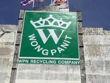 Green Wongpanit sign reading WPN Recycling Company on the front of the building, with flags above.